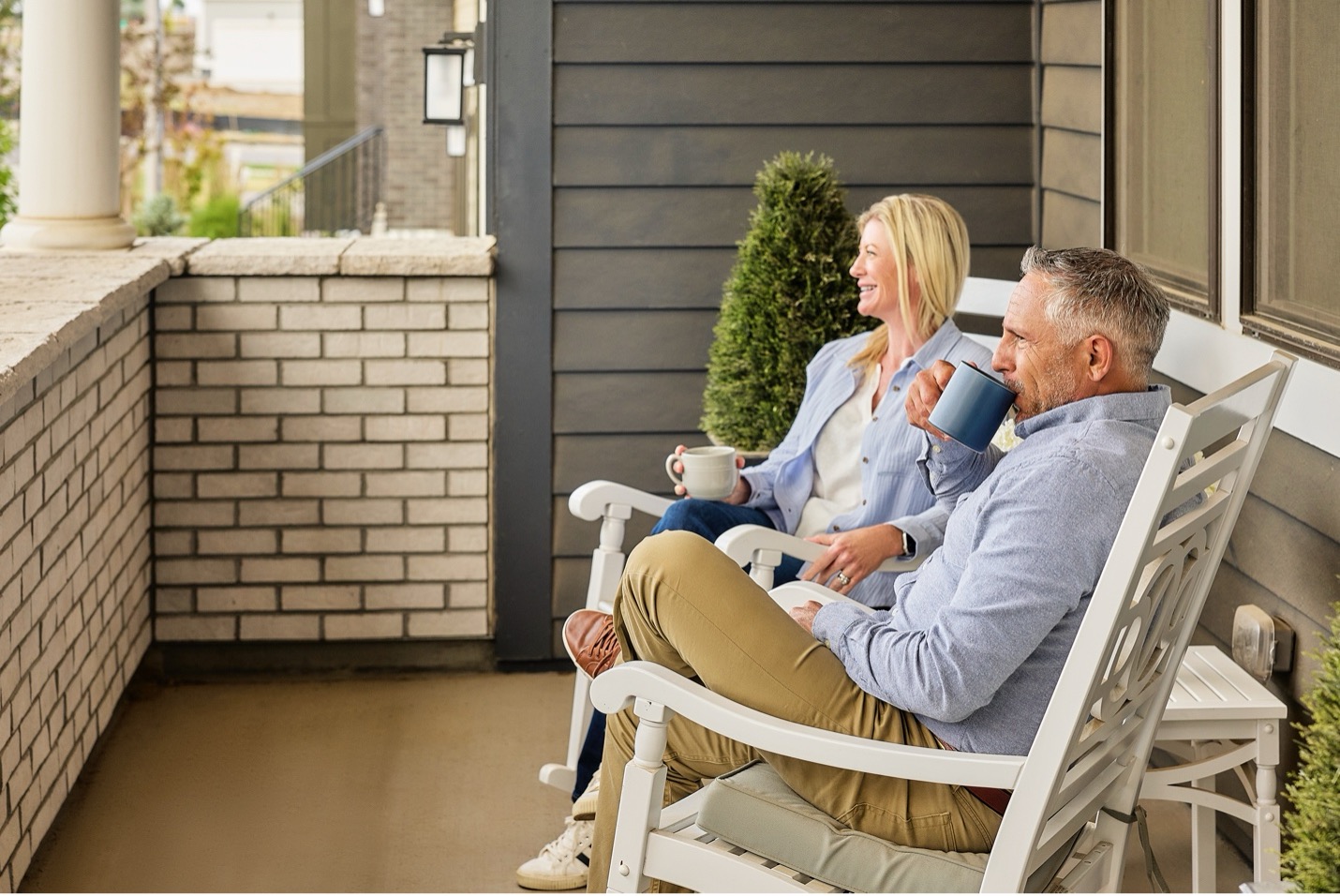 Couple Gathered on the back porch overlooking a southern Land Master Planned Community