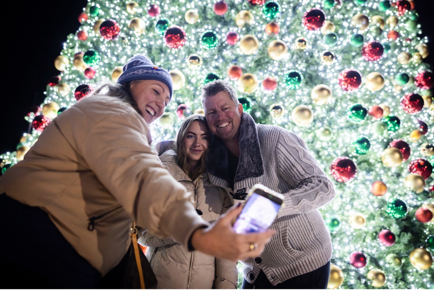 Family Gathers or a Photo in front of Southern Land Company’s Westerly Annual Tree Lighting Event
