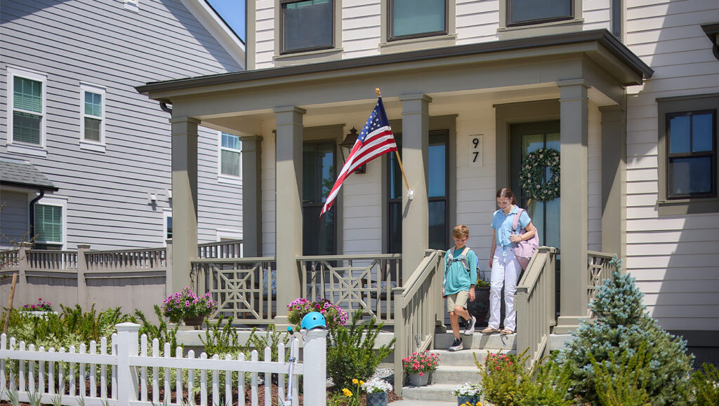 Two-kids-beginning-their-walk-to-school-from-Southern-Land-Company-community,-Westerly-in-Colorado
