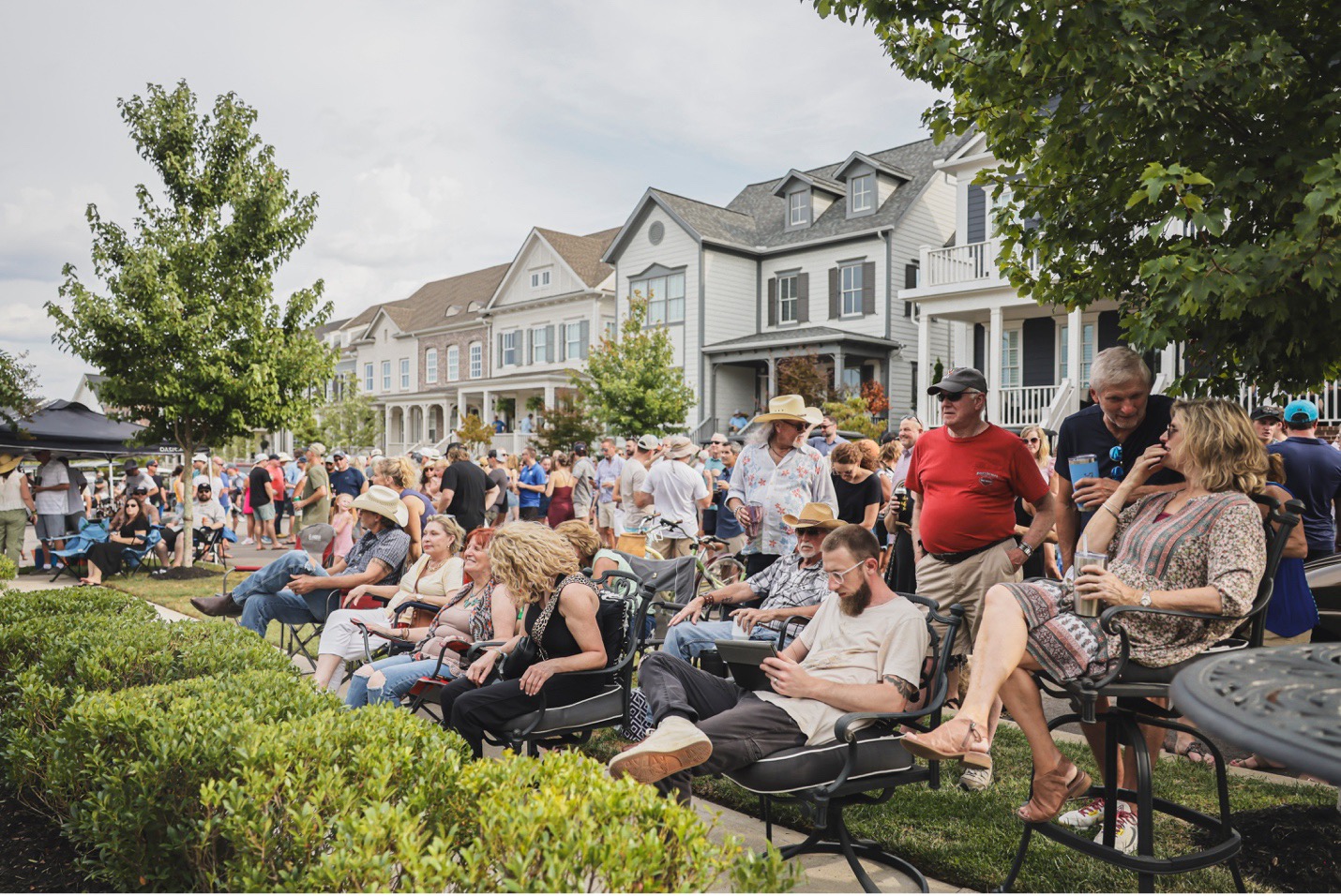 Neighbors Gathered to hear live music play at a Lifestyle Manager Planned Event in a Southern Land Company Community