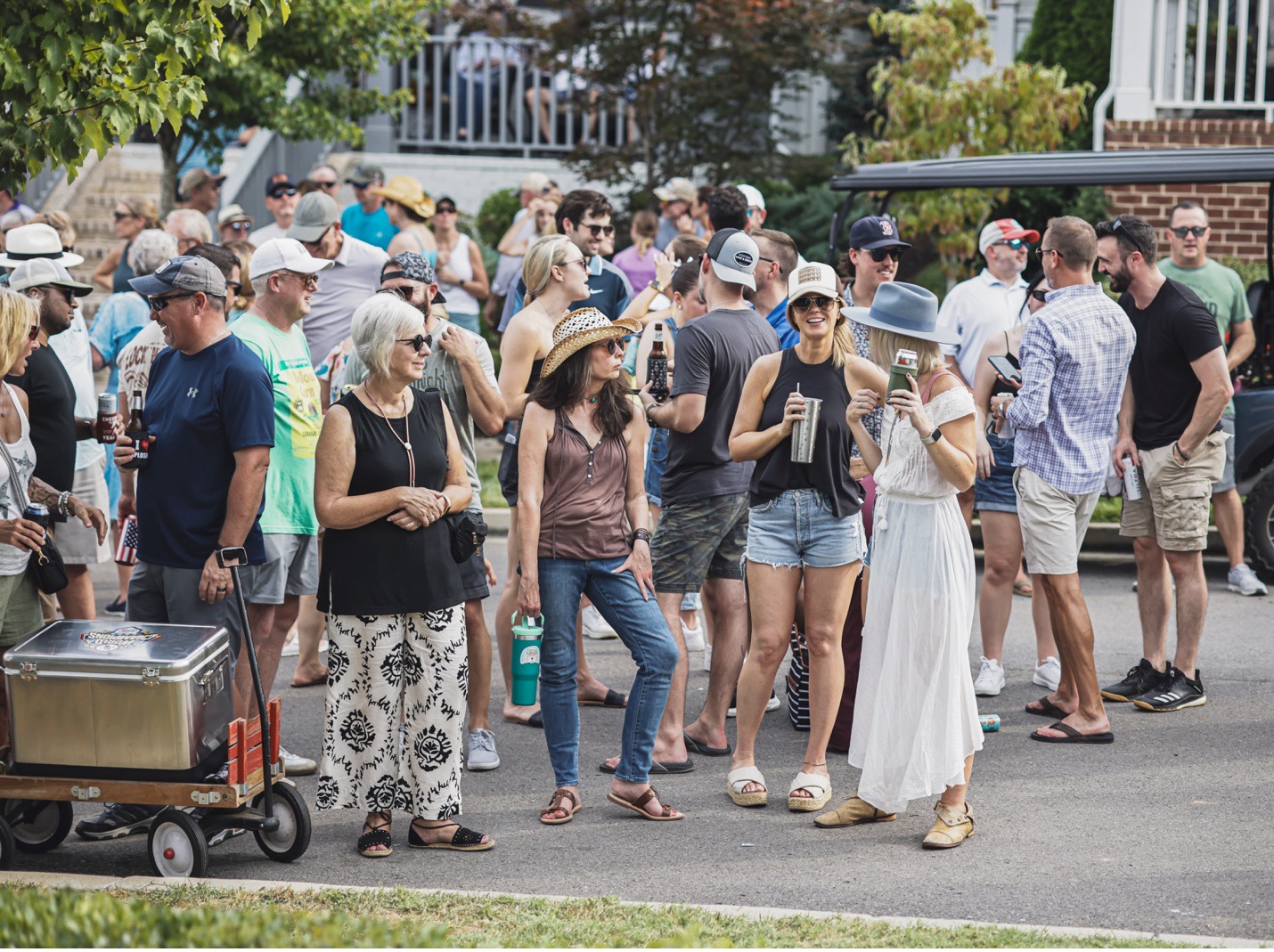 Women Gather Chatting at Westhaven’s Porchfest, surrounded by lively neighbors